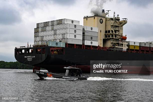 Members of the Coast Guard Command of the Ecuadorian Navy sail on a patrol along tributary channels of the Guayas River next to port terminals while...