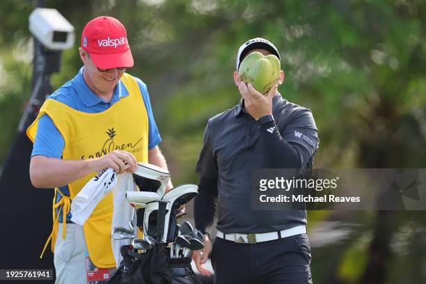 Alejandro Tosti of Argentina drinks from a coconut on the fifth tee during the first round of the Sony Open in Hawaii at Waialae Country Club on...