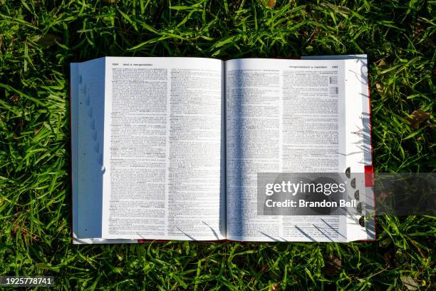 In a photo illustration, a Merriam-Webster's dictionary is seen placed on a lawn on January 11, 2024 in Austin, Texas. The Escambia County, Florida...