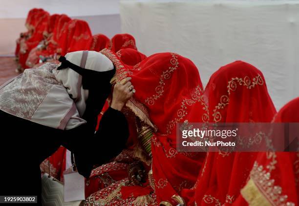Woman is talking with the bride during a Muslim mass marriage ceremony in Mumbai, India, on January 14, 2024.