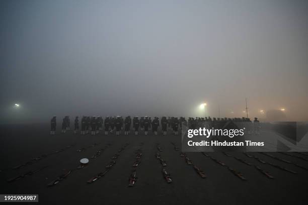 Amid zero visibility thick fog blankets, Indian coast guard personnel rehearse for the upcoming Republic Day parade, at Vijay Chowk, on January 14,...