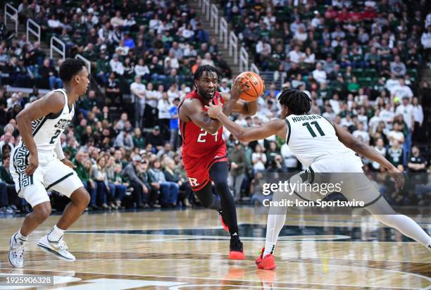 Rutgers Scarlet Knights guard Austin Williams gets slapped across the arm by Michigan State Spartans guard A.J. Hoggard during a college basketball...