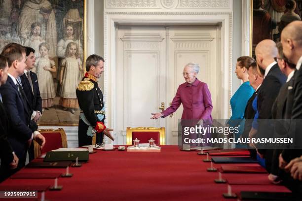 After signing the declaration of abdication Queen Margrethe II of Denmark leaves the seat at the head of the table to her son King Frederik X of...