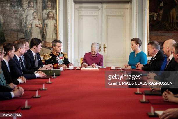 Queen Margrethe II of Denmark signs a declaration of abdication next to her son King Frederik X of Denmark, the new Crown Prince Christian of Denmark...