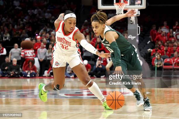 DeeDee Hagemann of the Michigan State Spartans moves the ball past Cotie McMahon of the Ohio State Buckeyes during the first quarter of the game at...