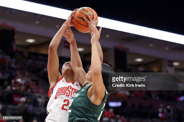 Moira Joiner of the Michigan State Spartans and Taylor Thierry of the Ohio State Buckeyes compete for a rebound during the first quarter of the game...
