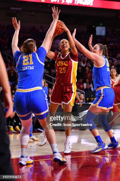 Trojans guard McKenzie Forbes goes up for a shot defended by UCLA Bruins forward Lina Sontag and UCLA Bruins forward Angela Dugalic during the...