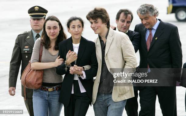 Freed Colombia hostage Ingrid Betancourt holds the hands of her children Melanie and Lorenzo Delloye, on their reunion after Betancourt six years of...