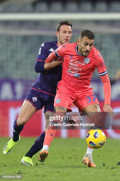 Arthur Melo of ACF Fiorentina battles for the ball with Roberto Pereyra of Udinese Calcio during the Serie A TIM match between ACF Fiorentina and...