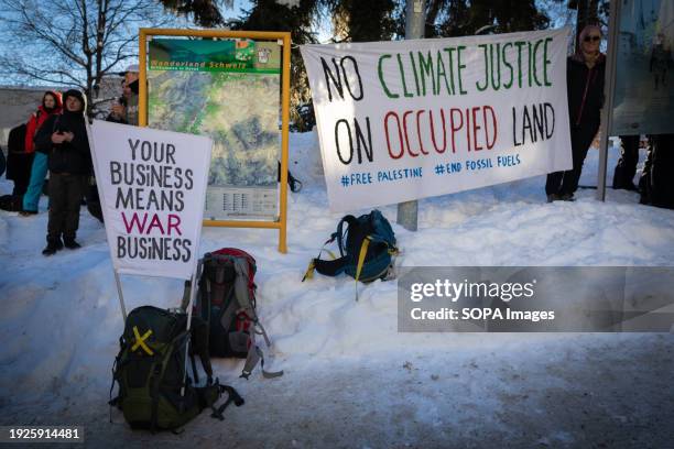 Banners are seen during a rally against the 54th World Economic Forum. Hundreds of protesters gathered to voice concerns about this year's World...