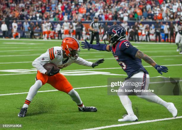 Cleveland Browns wide receiver David Bell stiff arms Houston Texans safety Jalen Pitre in the second quarter during the AFC Wild Card game between...