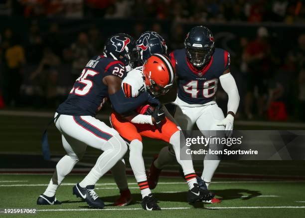 Houston Texans cornerback Desmond King II tackles Cleveland Browns wide receiver David Bell in the first quarter during the AFC Wild Card game...