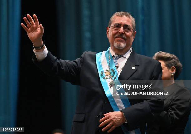 Guatemala's new President Bernardo Arevalo waves after being inaugurated at the Miguel Angel Asturias Cultural Centre in Guatemala City, early on...