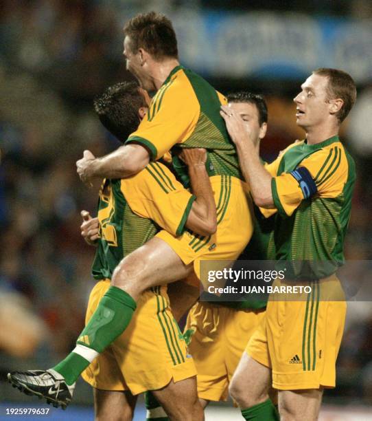 Australian players : Paul Agostino, David Zdrilic, Craig Moore and Steve Laybutt, celebrate after scoring against Venezuela during their friendly...