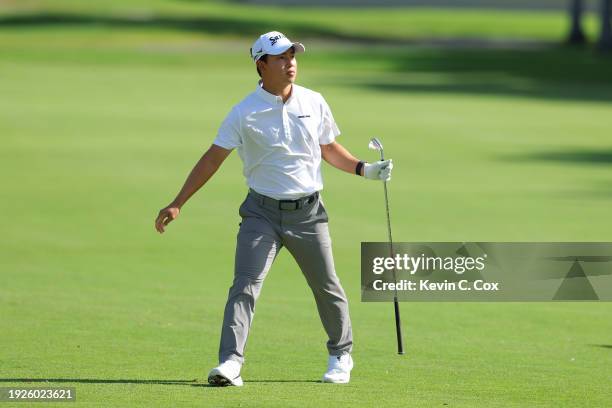 Yuto Katsuragawa of Japan follows his shot on the 16th hole during the first round of the Sony Open in Hawaii at Waialae Country Club on January 11,...