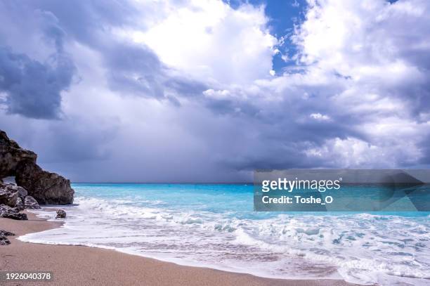 turquoise sea horizon with rocks, dramatic clouds and waves - grekiska övärlden bildbanksfoton och bilder