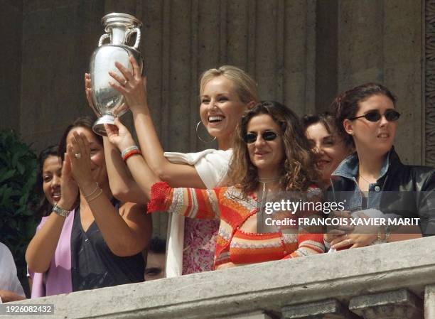Slovak top model Adriana Karembeu , wife of French player Christian Karembeu, smiles as she displays the European Cup to the fans gathered 03 July...