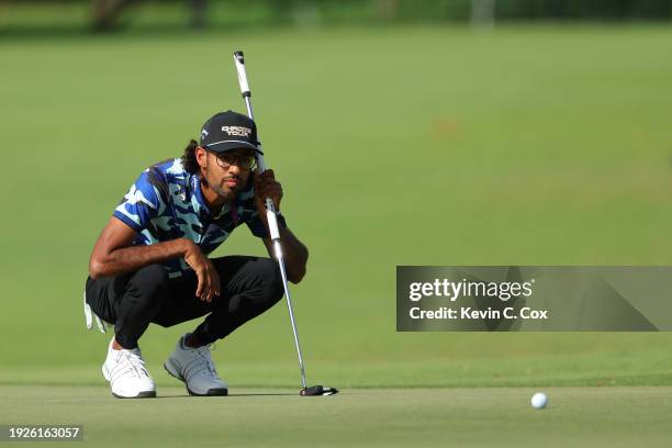 Akshay Bhatia of the United States lines up a putt on the eighth green during the first round of the Sony Open in Hawaii at Waialae Country Club on...