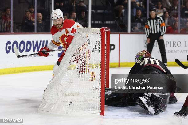 Rasmus Andersson of the Calgary Flames reacts after scoring a goal past goaltender Karel Vejmelka of the Arizona Coyotes during the first period of...