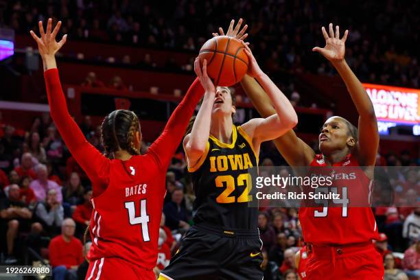 Caitlin Clark of the Iowa Hawkeyes in action against Antonia Bates and Chyna Cornwell of the Rutgers Scarlet Knights during a game at Jersey Mike's...