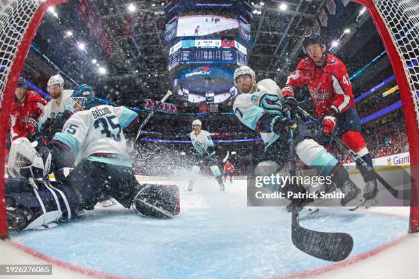 Jordan Eberle of the Seattle Kraken and Martin Fehervary of the Washington Capitals collide in front of the net during the second period at Capital...