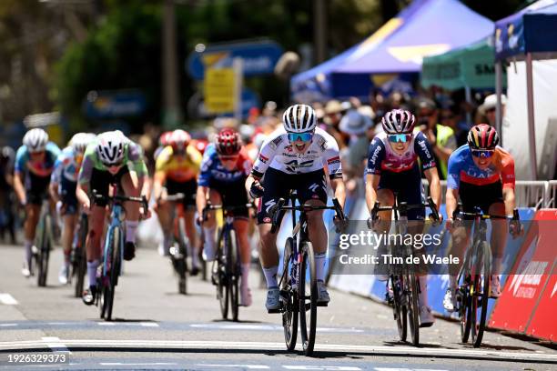 Ally Wollaston of New Zealand and AG Insurance - Soudal Team celebrates at finish line as stage winner ahead of Georgia Baker of Australia and Team...