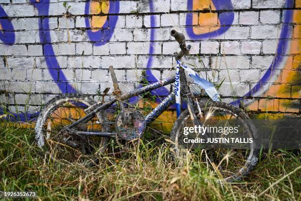 Rusting bicycle with police crime scene tape on is pictured next to the Grand Union Canal by Scrubs Lane on July 2 where days earlier Victor Lee was...