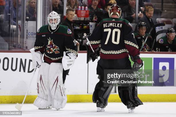Goaltender Connor Ingram of the Arizona Coyotes replaces Karel Vejmelka during the first period of the NHL game against the Calgary Flames at Mullett...