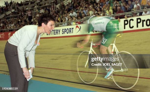 English Chris Boardman's wife Sally cheer her husband who races to set new one-hour World Record at 49.441 kms on the track of Manchester during the...