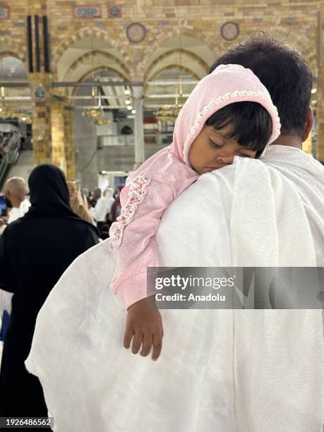 Child carried by Muslim worshipper circumambulating the Kaaba at Masjid al-Haram in Mecca, Saudi Arabia on December 30, 2023.