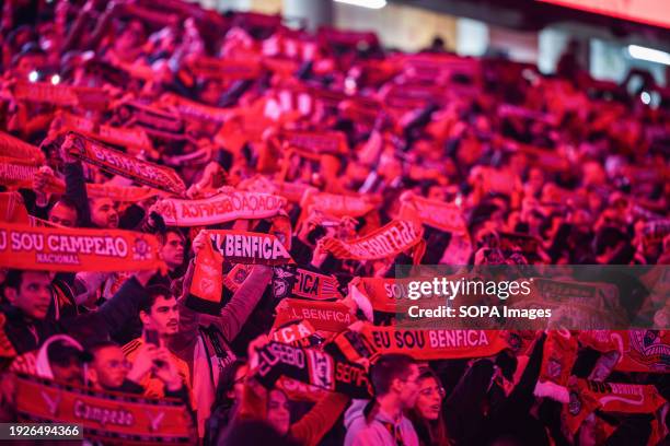 Benfica fans sing with scarves before the match between SL Benfica and Rio Ave FC at Estadio da Luz for Liga Portugal Betclic at Estadio da Luz. .