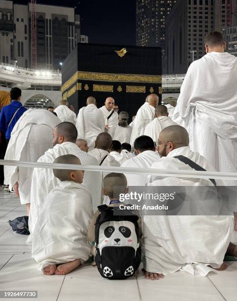 Muslim worshippers pray with their children at the Kaaba at Masjid al-Haram in Mecca, Saudi Arabia on December 30, 2023.