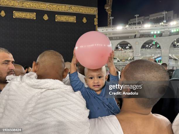 Child carried on the shoulders of Muslim worshipper circumambulating the Kaaba at Masjid al-Haram in Mecca, Saudi Arabia on December 30, 2023.