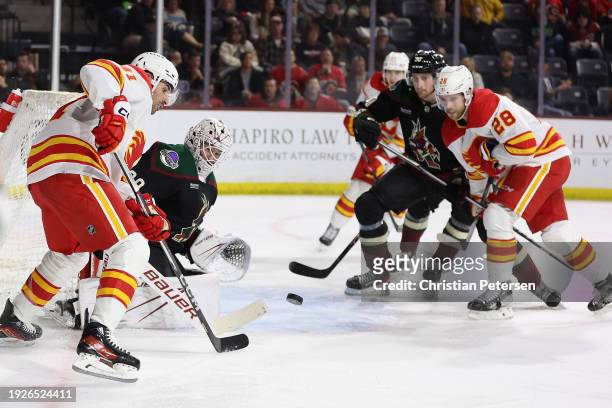 Nazem Kadri of the Calgary Flames controls the puck ahead of goaltender Connor Ingram of the Arizona Coyotes during the third period of the NHL game...