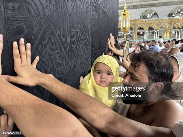 Child carried on the shoulders of Muslim worshipper circumambulating the Kaaba at Masjid al-Haram in Mecca, Saudi Arabia on December 30, 2023.