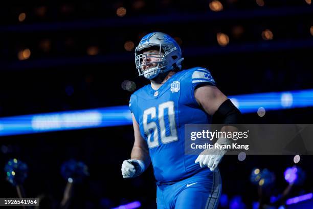 Graham Glasgow of the Detroit Lions runs onto the field during player introductions before an NFL football game against the Denver Broncos at Ford...