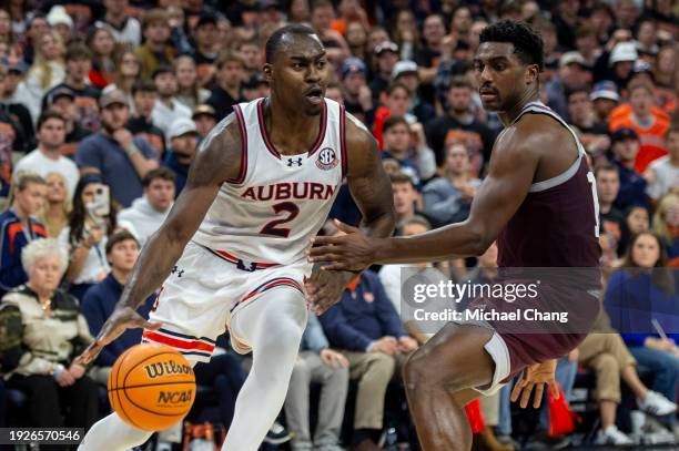 Jaylin Williams of the Auburn Tigers maneuvers the ball by Henry Coleman III of the Texas A&M Aggies at Neville Arena on January 09, 2024 in Auburn,...