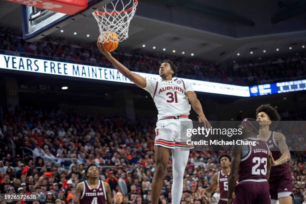 Chaney Johnson of the Auburn Tigers attempts a layup in front of Tyrece Radford of the Texas A&M Aggies and Andersson Garcia of the Texas A&M Aggies...