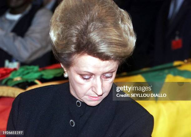 Colette Senghor, the widow of former Senegales president Leopold Sedar Senghor, stands next to his coffin draped in the Senegalese national flag 29...