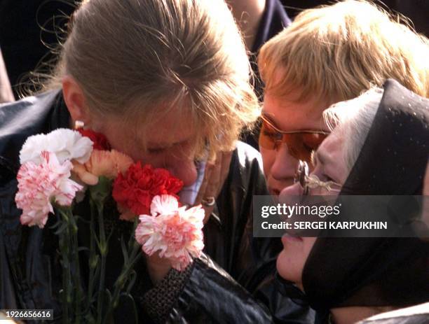 Family members of a Kursk submarine victim cry during a memorial ceremony in the Russian Arctic port of Vidyayevo, 12 August 2001. Families of the...