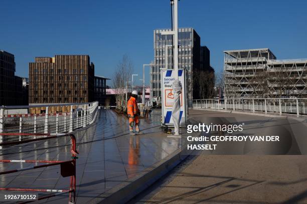 Photo shows workers on the construction site of the 2024 Olympic Villlage in Saint-Denis, north of Paris on January 15, 2024. The Paris Olympics are...