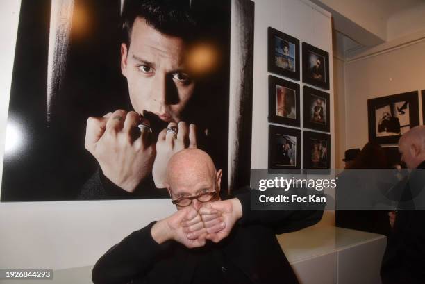 Photographer Arnaud Baumann poses with his portrait of Johnny Depp during Arnaud Baumann’s “Iconic Portraits” Preview at Galerie idan on January 11,...