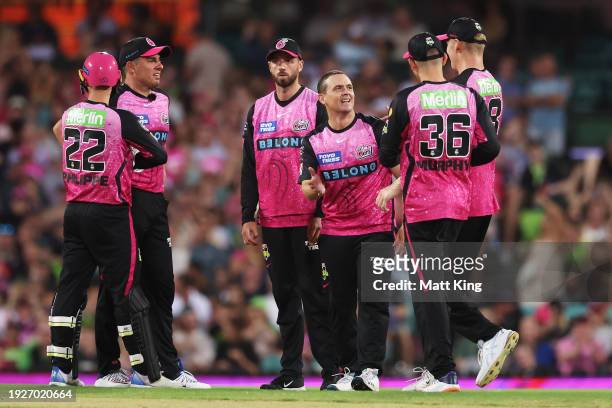 Stephen O’Keefe of the Sixers celebrates with team mates after taking the wicket of Alex Hales of the Thunder during the BBL match between Sydney...