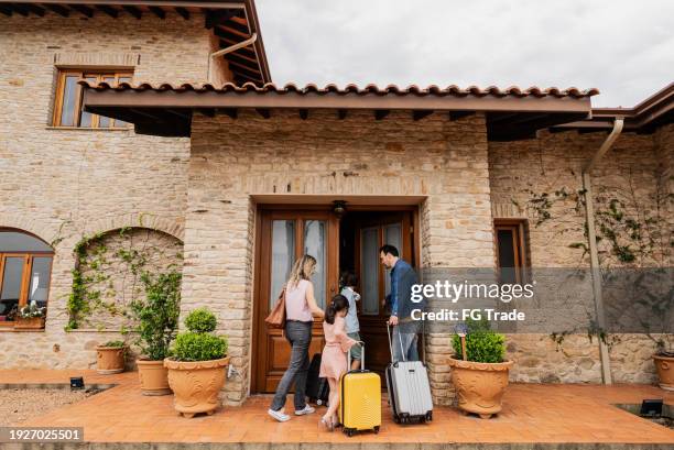 family arriving at a hotel - open marriage stock pictures, royalty-free photos & images