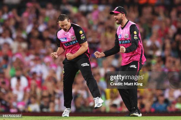 Stephen O’Keefe of the Sixers celebrates with team mates after taking the wicket of Cameron Bancroft of the Thunder during the BBL match between...