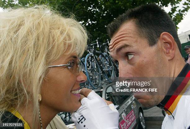 German Erik Zabel talks to his wife before the start of the first stage of the 90th Tour de France, 06 July 2003 in Saint-Denis. AFP PHOTO FRANCK FIFE