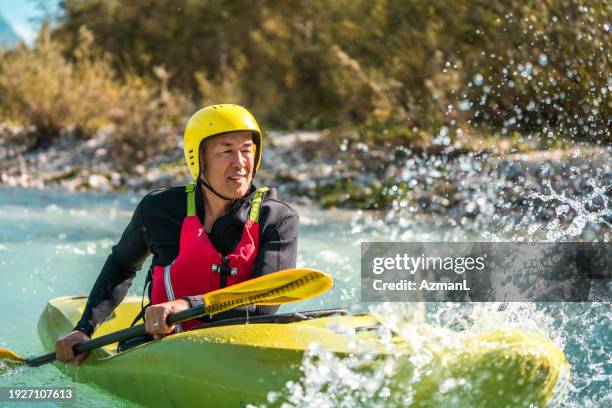 asian male kayaking adventure in mountain river - white water rafting stock pictures, royalty-free photos & images