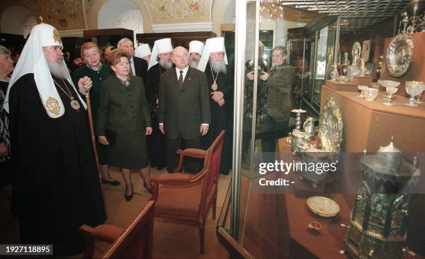 Russian Orthodox Patriarch Alexy II, left, President Boris Yeltsin's wife Naina, center foreground, and Moscow mayor Yuri Luzhkov look at exhibits...