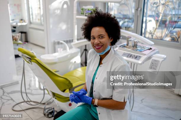 dentist's commitment to patient health - female dentist stock pictures, royalty-free photos & images