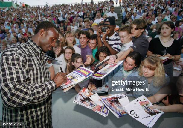 Olympic, World and European 100m gold medallist Linford Christie of Great Britain signs autographs for young fans at the IAAF Mobil London Grand Prix...